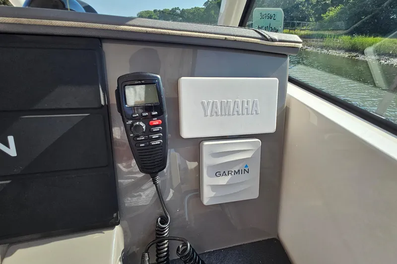 Slide: The Image of 2018 Pursuit DC 295 Dual Console boat interior with Yamaha and Garmin equipment. - 31