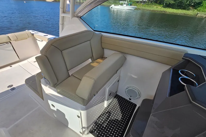 Slide: The Image of 2018 Pursuit DC 295 Dual Console boat interior with seating and water view. - 33