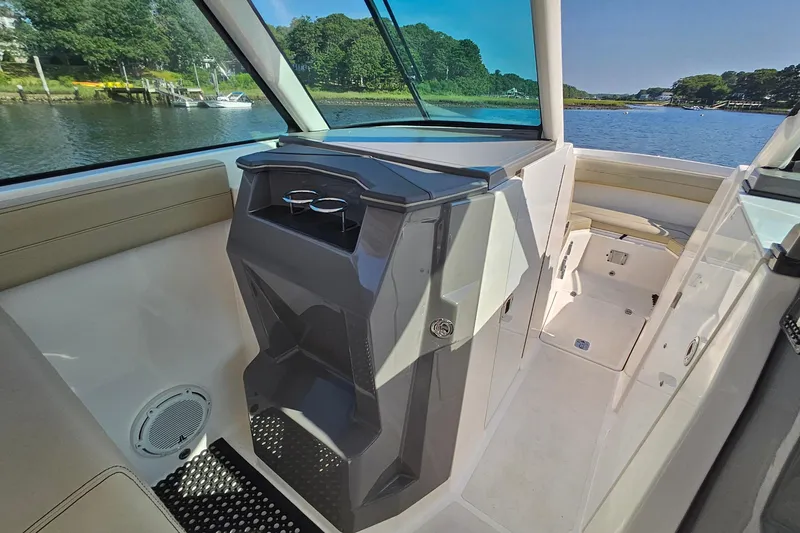 Slide: The Image of 2018 Pursuit DC 295 Dual Console interior with cup holders, scenic water view. - 35