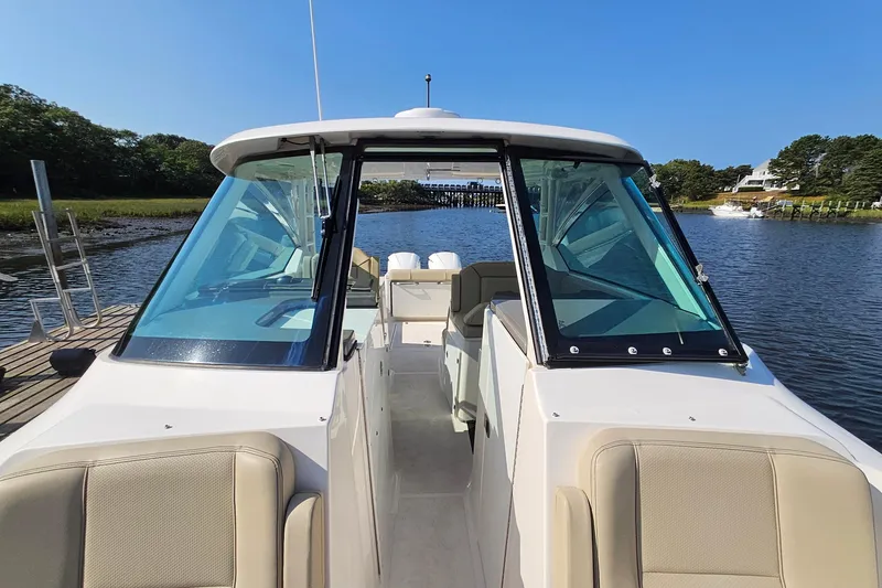 Slide: The Image of 2018 Pursuit DC 295 Dual Console boat docked on a sunny day. - 36