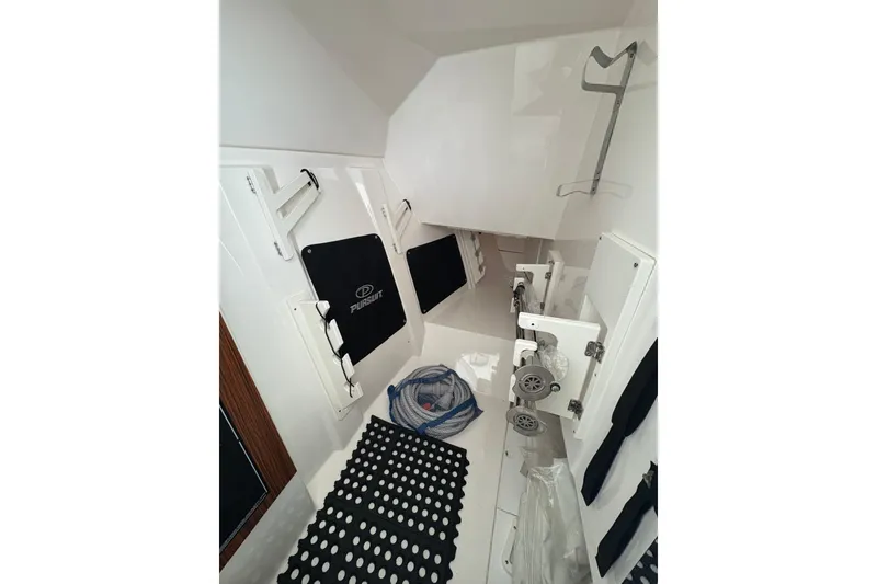 Slide: The Image of 2018 Pursuit DC 295 Dual Console interior with storage compartments and equipment. - 43