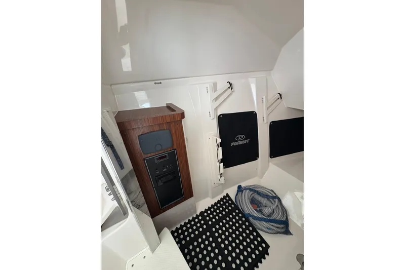 Slide: The Image of 2018 Pursuit DC 295 Dual Console interior with storage and equipment. - 44