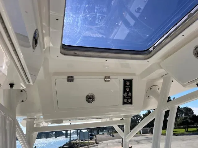 Slide: The Image of 2018 Sea Fox 248 Commander boat interior with overhead storage and control panel. - 28