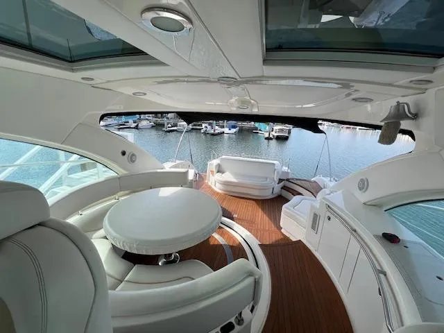 Slide: The Image of Luxurious 2008 Sea Ray 55 Sundancer yacht interior with elegant seating and marina view. - 17