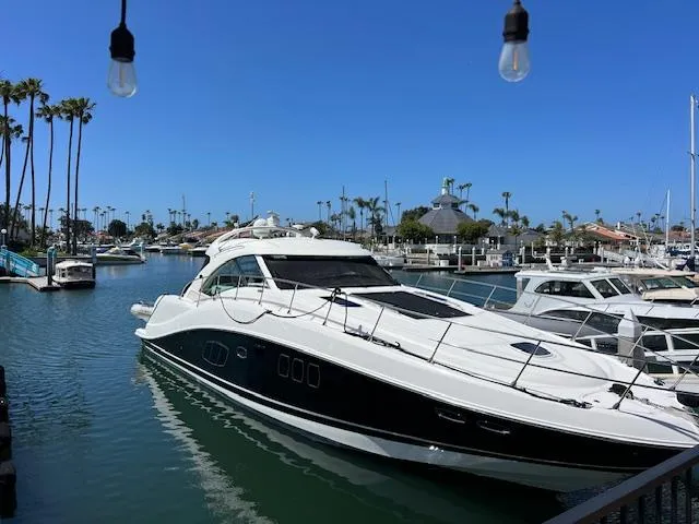 Slide: The Image of 2008 Sea Ray 55 Sundancer yacht docked in a sunny marina. - 2