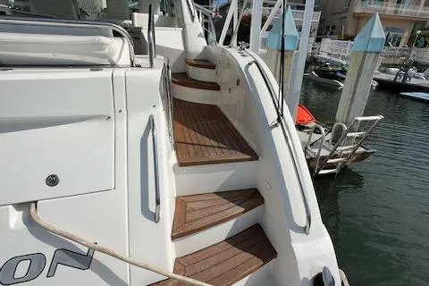 Slide: The Image of 2008 Sea Ray 55 Sundancer yacht with wooden steps at a marina dock. - 24