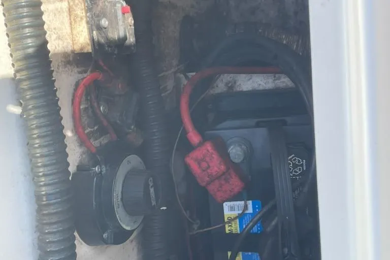 Slide: The Image of Battery compartment of a 2008 Parker 2310 Walkaround boat with visible wiring and connections. - 10