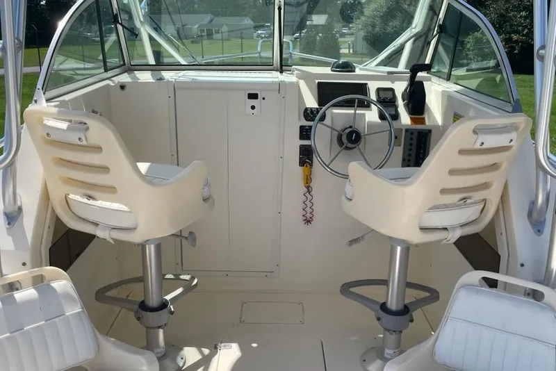 Slide: The Image of 2008 Parker 2310 Walkaround boat interior with steering wheel and two seats. - 11