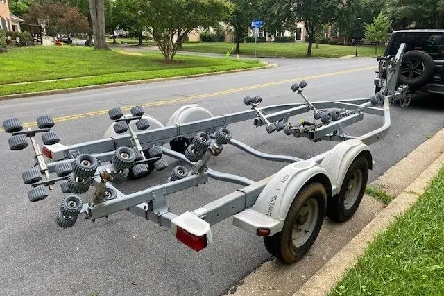 Slide: The Image of Trailer for 2008 Parker 2310 Walkaround boat parked on a suburban street. - 16
