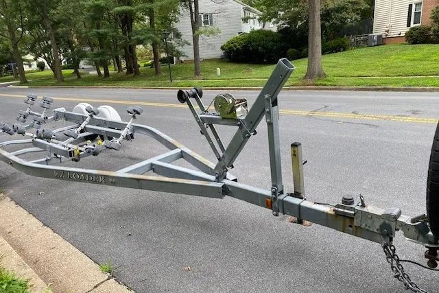 Slide: The Image of Trailer for 2008 Parker 2310 Walkaround boat parked on suburban street. - 17