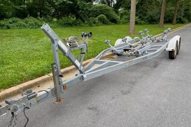 Slide: The Image of Boat trailer for 2008 Parker 2310 Walkaround on a paved road near greenery. - 19