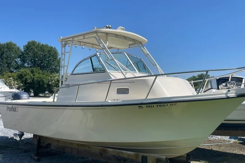 Slide: The Image of 2008 Parker 2310 Walkaround boat on display, clear sky background. - 2