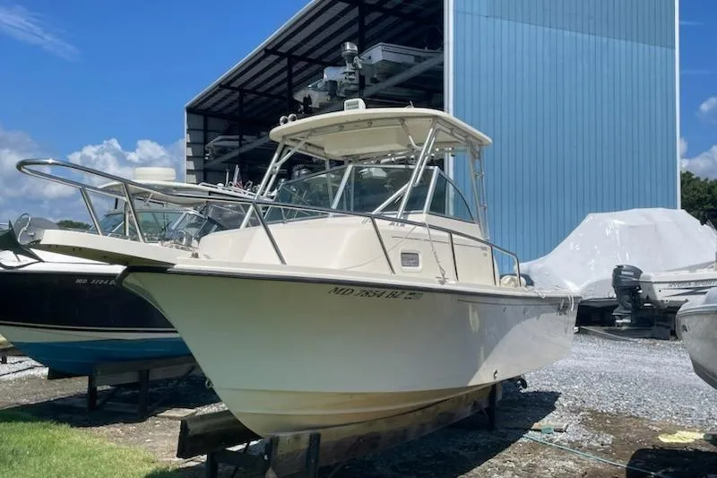 Slide: The Image of 2008 Parker 2310 Walkaround boat in storage, outdoor setting, clear sky. - 3