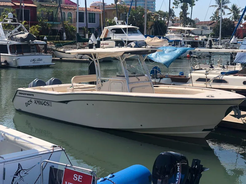 The Image of 2006 Grady-White Bimini 306 boat docked in a marina with other vessels. - 0