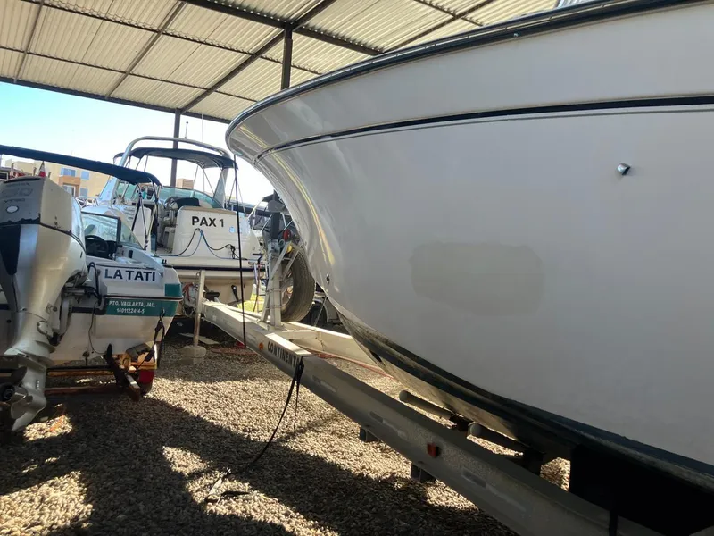 Slide: The Image of 2006 Grady-White Bimini 306 boat in storage, alongside other vessels. - 14