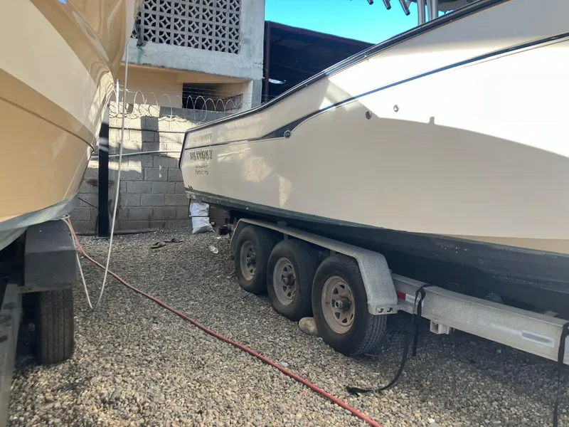 Slide: The Image of 2006 Grady-White Bimini 306 boat on a trailer in a gravel yard. - 18