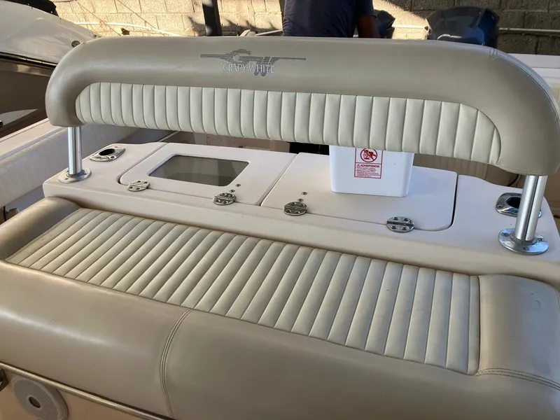 Slide: The Image of 2006 Grady-White Bimini 306 boat interior with cushioned seating and control panel. - 22