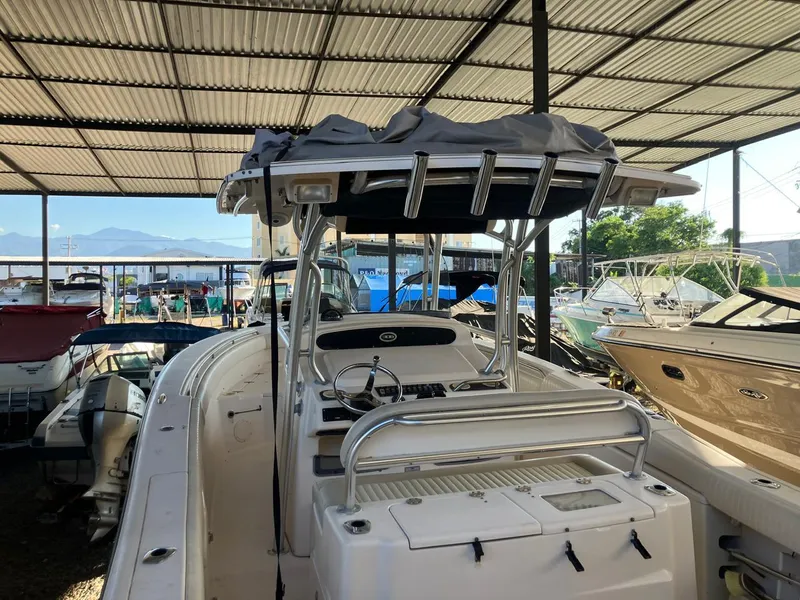 Slide: The Image of 2006 Grady-White Bimini 306 boat in covered storage, surrounded by other vessels. - 23