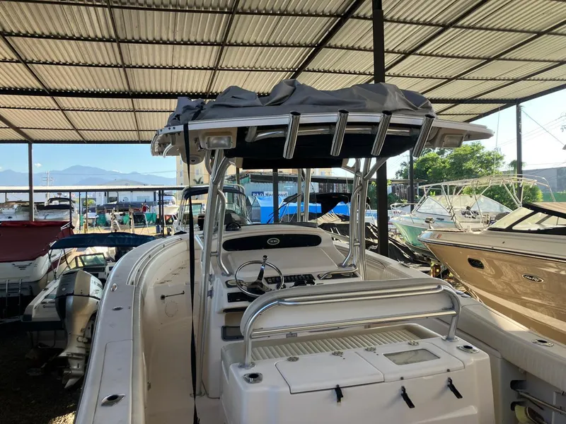 Slide: The Image of 2006 Grady-White Bimini 306 boat in covered storage, surrounded by other vessels. - 24