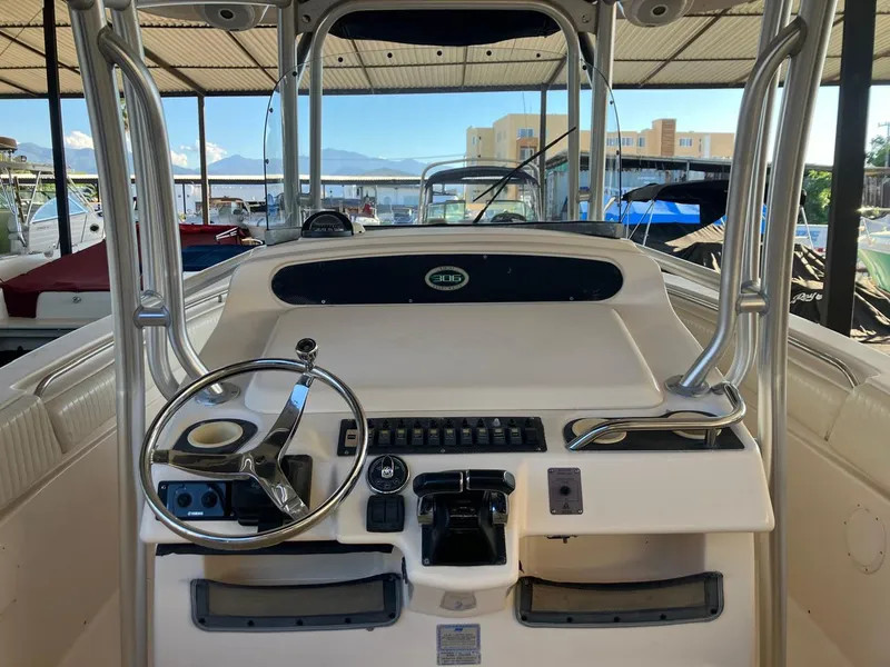 Slide: The Image of 2006 Grady-White Bimini 306 boat dashboard with steering wheel and controls. - 25