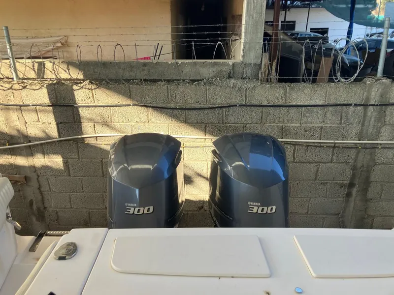 Slide: The Image of 2006 Grady-White Bimini 306 with twin Yamaha 300 engines, docked near concrete wall. - 26