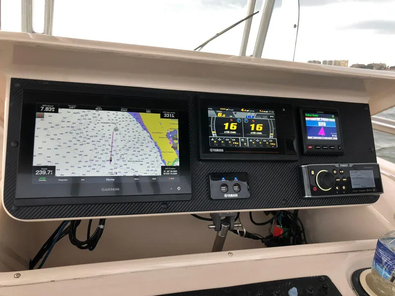 Slide: The Image of 2006 Grady-White Bimini 306 dashboard with navigation and control systems. - 5