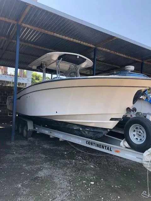 Slide: The Image of 2006 Grady-White Bimini 306 boat on trailer under metal shelter. - 7