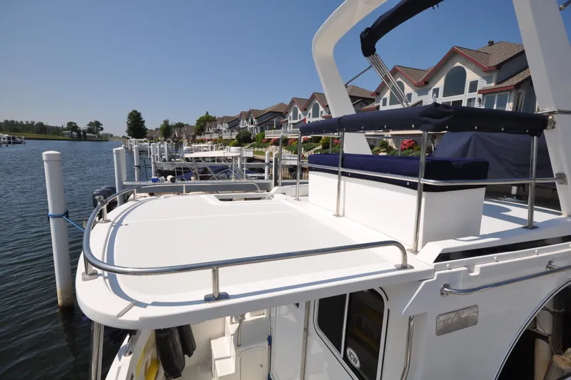 Slide: The Image of 2015 Helmsman Trawlers 31 Sedan docked near waterfront homes. - 11