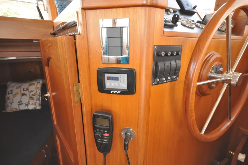 Slide: The Image of Helmsman Trawlers 31 Sedan 2015 interior helm with controls and steering wheel. - 27