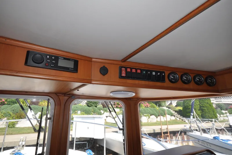 Slide: The Image of Interior view of 2015 Helmsman Trawlers 31 Sedan dashboard with control panel and gauges. - 28