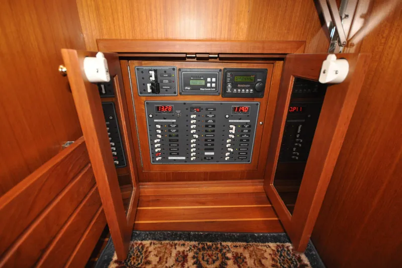Slide: The Image of Electrical panel inside 2015 Helmsman Trawlers 31 Sedan, featuring control switches and displays. - 30