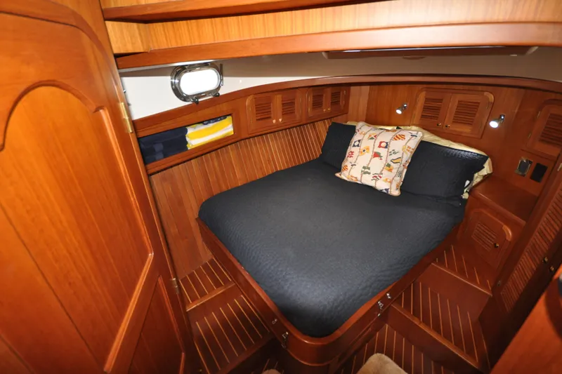 Slide: The Image of Cozy cabin interior of 2015 Helmsman Trawlers 31 Sedan with wood finish and comfortable bedding. - 32