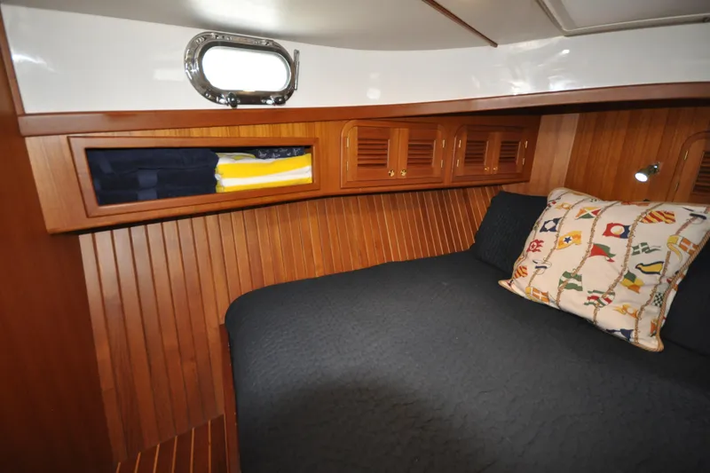 Slide: The Image of Cozy cabin interior of 2015 Helmsman Trawlers 31 Sedan with nautical-themed pillow. - 33