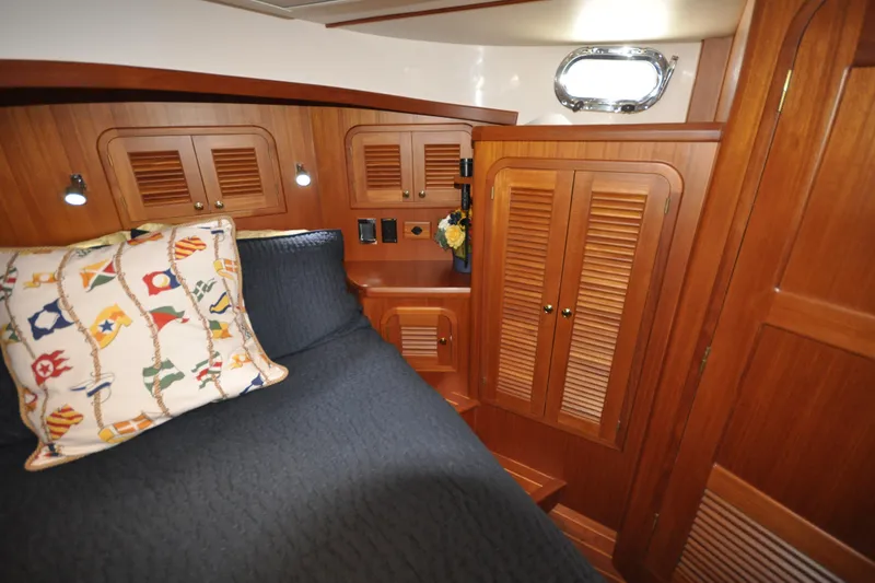 Slide: The Image of Cozy cabin interior of 2015 Helmsman Trawlers 31 Sedan with wood paneling and nautical decor. - 35