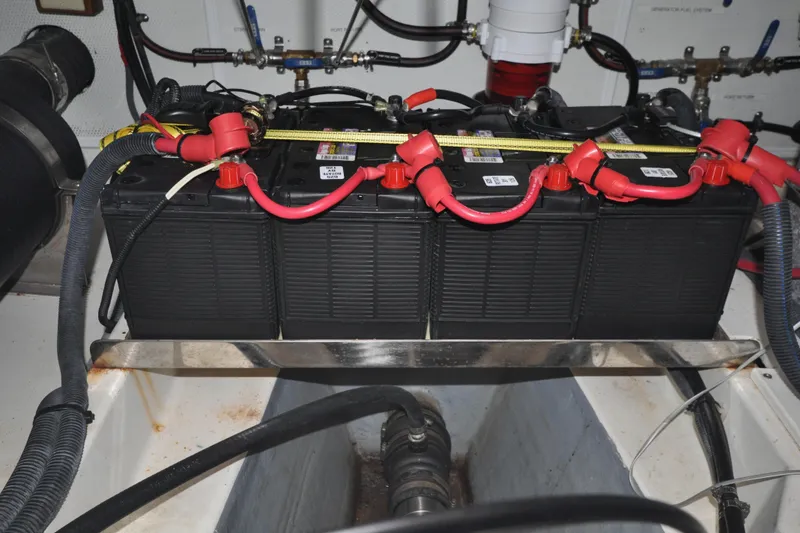 Slide: The Image of Battery compartment of 2015 Helmsman Trawlers 31 Sedan with red cables and connectors. - 47