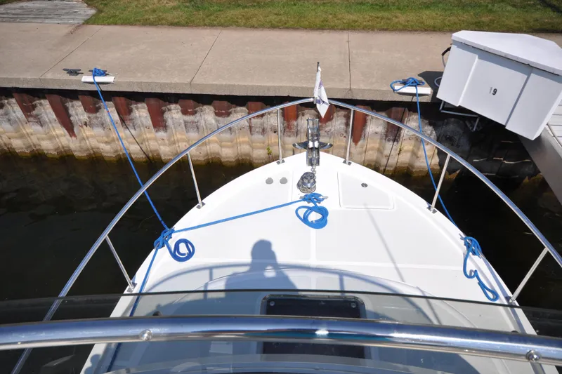 Slide: The Image of Helmsman Trawlers 31 Sedan 2015 docked, view from bow with blue ropes. - 49