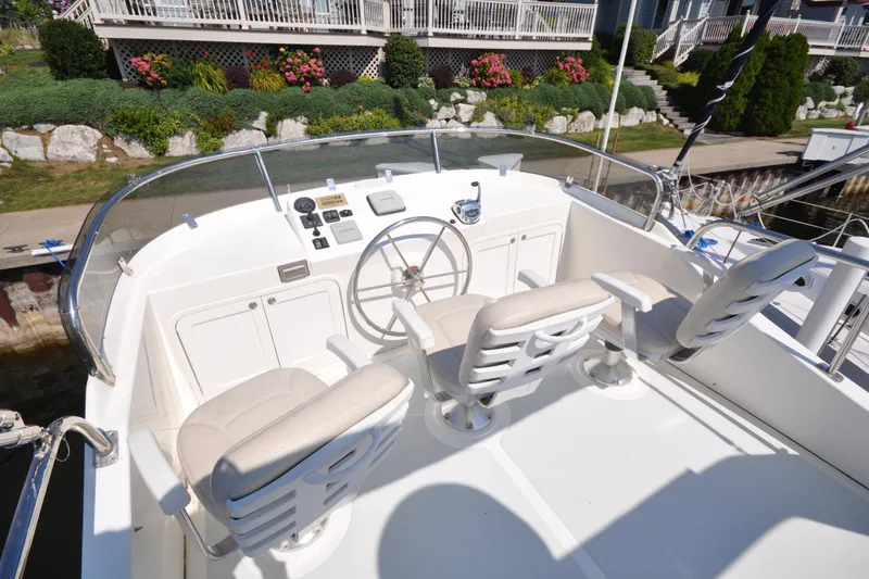 Slide: The Image of Helmsman Trawlers 31 Sedan 2015 boat helm with three seats and steering wheel. - 50