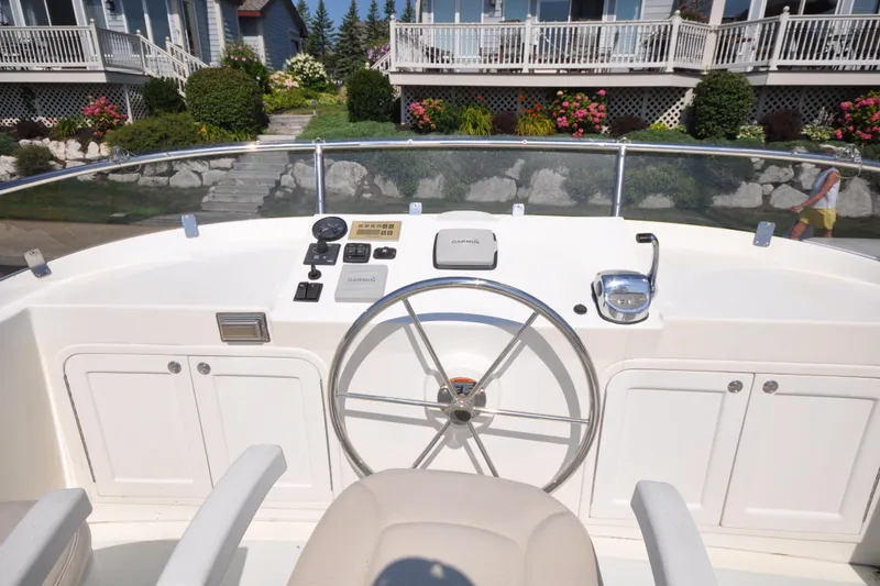 Slide: The Image of Helmsman Trawlers 31 Sedan 2015 helm with steering wheel and controls. - 51
