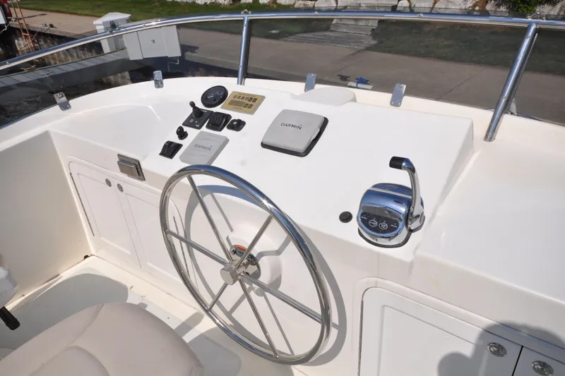 Slide: The Image of Helmsman Trawlers 31 Sedan 2015 helm with steering wheel and navigation controls. - 52