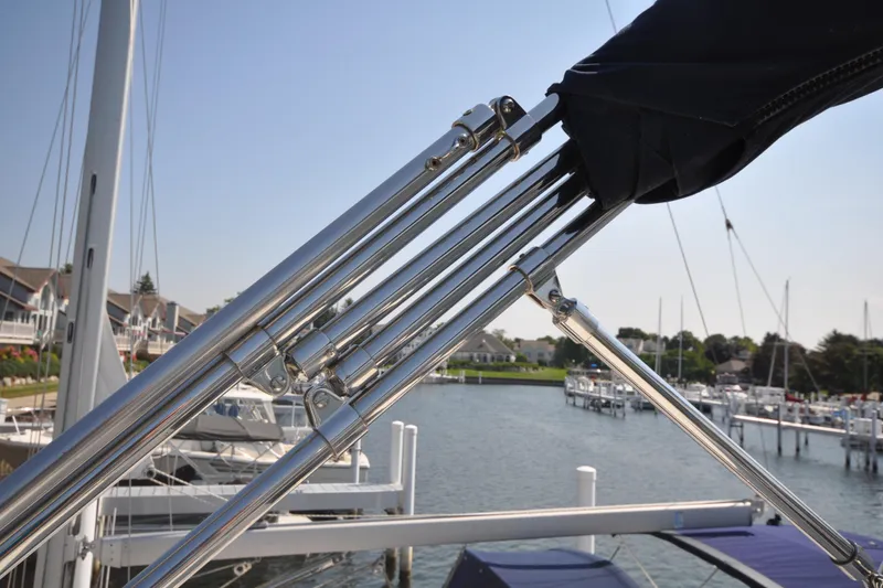 Slide: The Image of 2015 Helmsman Trawlers 31 Sedan with stainless steel fittings at a marina. - 58