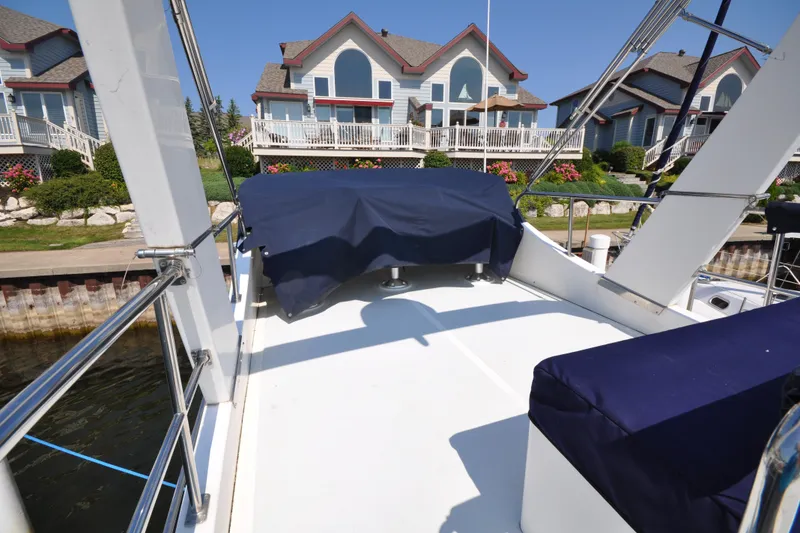 Slide: The Image of Helmsman Trawlers 31 Sedan 2015 on deck, with waterfront homes in the background. - 60