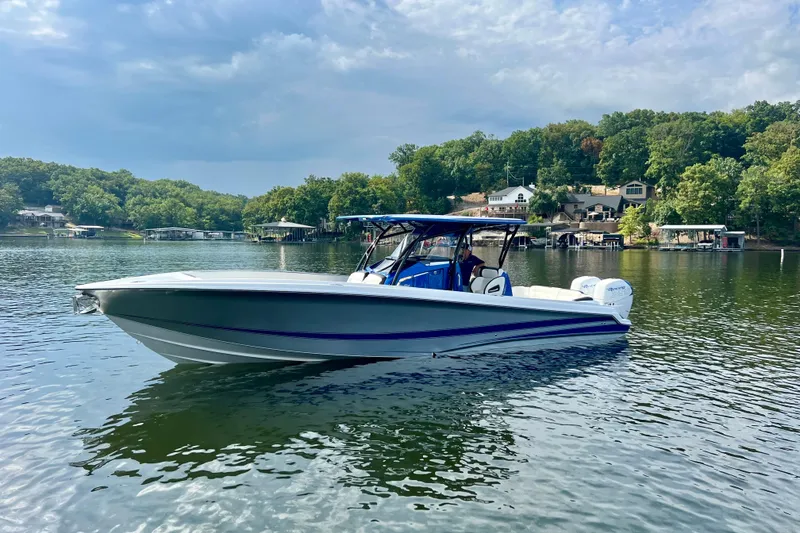 The Image of 2020 Nor-Tech 340 Sport Center Console boat on a serene lake. - 1