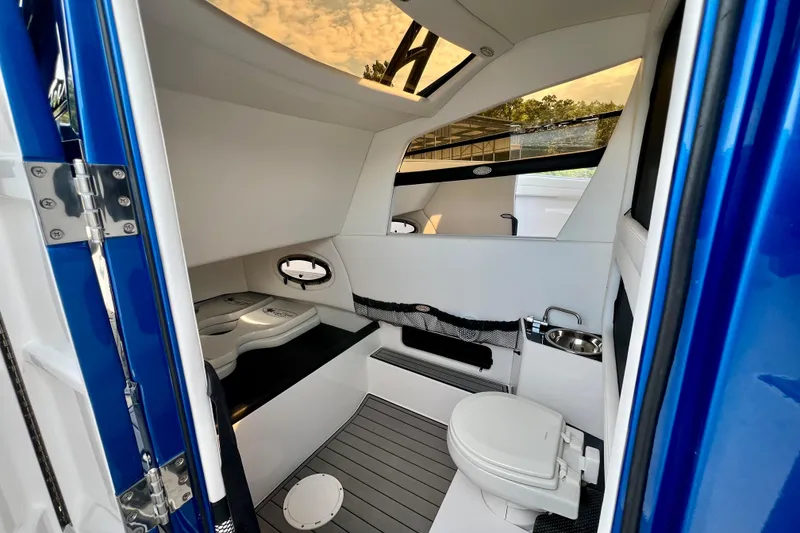 Slide: The Image of 2020 Nor-Tech 340 Sport Center Console cabin interior with modern amenities and sleek design. - 17