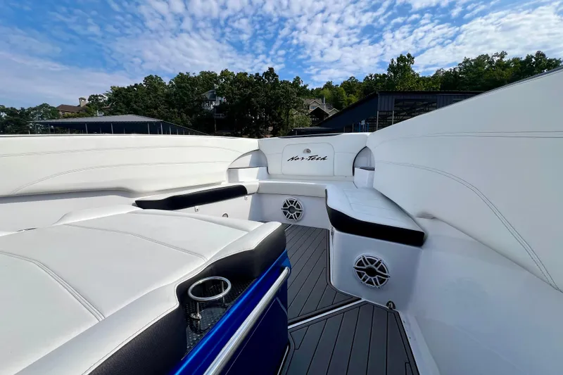 Slide: The Image of 2020 Nor-Tech 340 Sport Center Console boat interior with white seating and blue accents. - 22