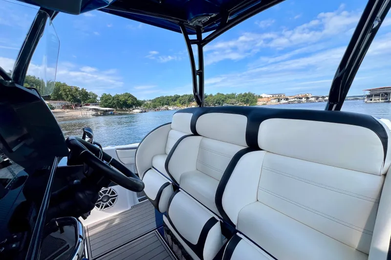 Slide: The Image of 2020 Nor-Tech 340 Sport Center Console interior with luxurious seating and scenic water view. - 28