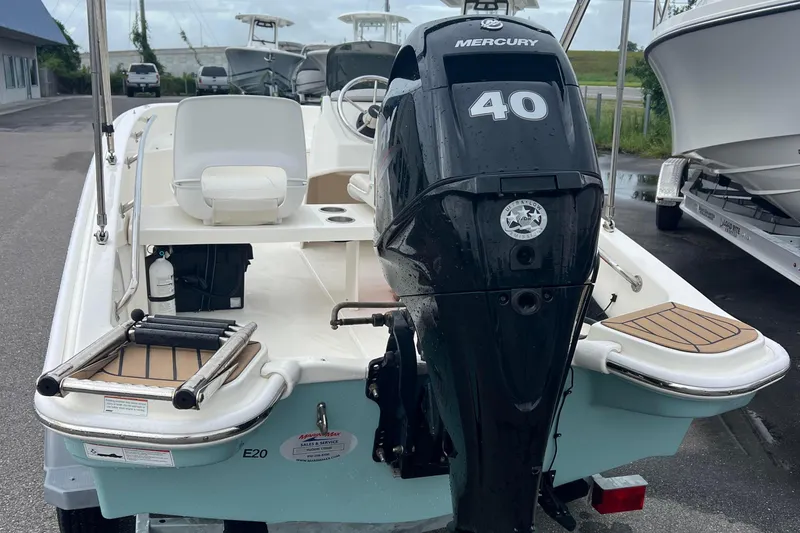 Slide: The Image of 2021 Boston Whaler 130 Super Sport with Mercury 40 engine, parked outdoors. - 2