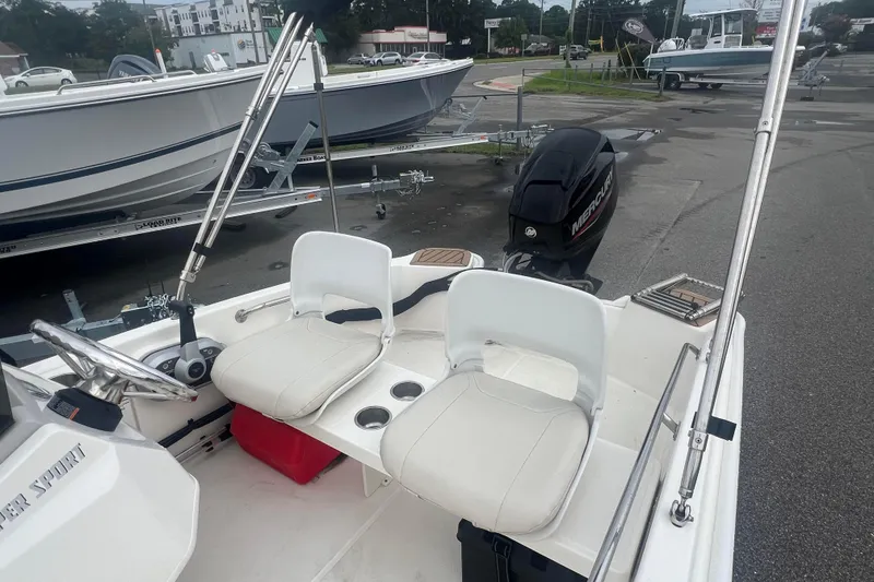 Slide: The Image of 2021 Boston Whaler 130 Super Sport boat interior with seating and Mercury engine. - 3