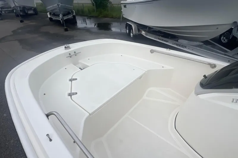 Slide: The Image of 2021 Boston Whaler 130 Super Sport boat interior, showcasing seating and storage area. - 4