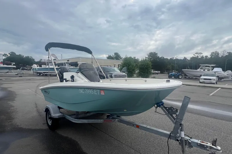 Slide: The Image of 2021 Boston Whaler 130 Super Sport boat on trailer in parking lot. - 8