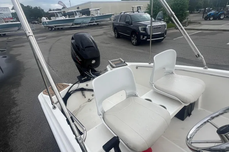 Slide: The Image of 2021 Boston Whaler 130 Super Sport boat with Mercury engine, parked in a lot. - 9